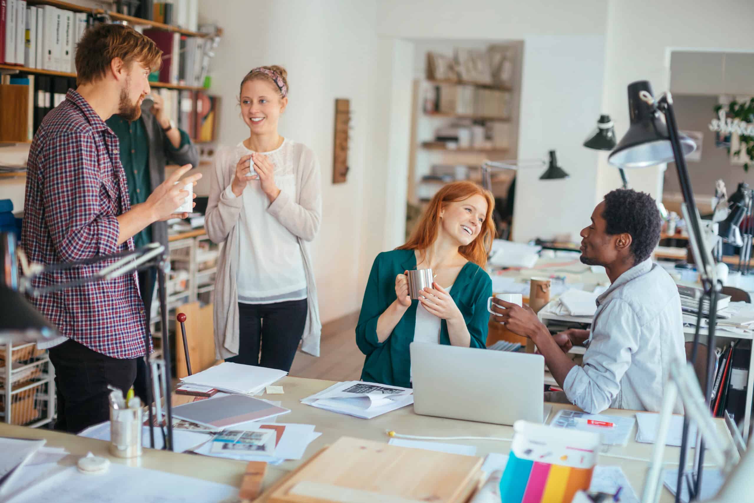 Diverse young people collaborating on a project in a modern workspace